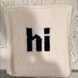 Cream Knit blanket  with Black 'hi' Design 26x26”